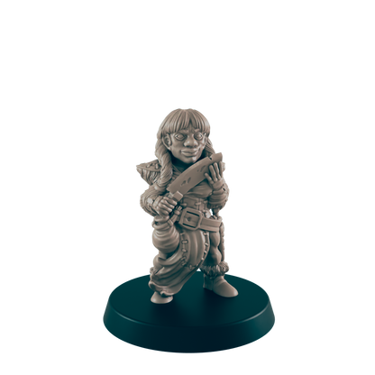A female miniature figurine, holding a knife, stands on a dark circular base against a black background.