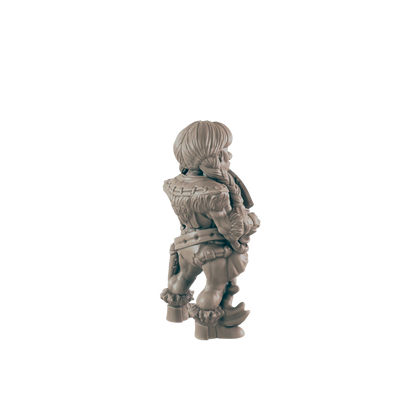 A small, fur-clad figurine stands, facing away, against a black background.  It appears to be a miniature of a humanoid creature with short hair and sturdy boots.