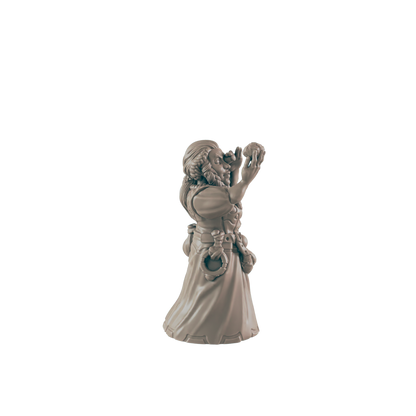A miniature figurine of a robed, bearded figure holds an object to their face, seemingly examining it; it is set against a plain black background.