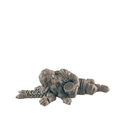 A dwarf miniature lies asleep, clutching a mug; the figure is on a plain background.