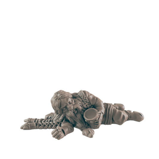 A dwarf miniature lies asleep, clutching a mug; the figure is on a plain background.