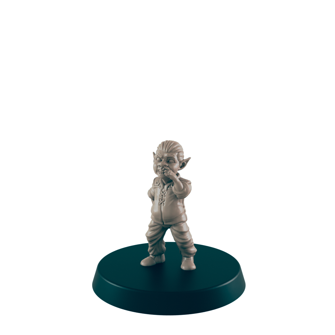 A small, tan goblin figurine stands on a dark circular base, covering its mouth, seemingly in contemplation or amusement against a plain dark background.