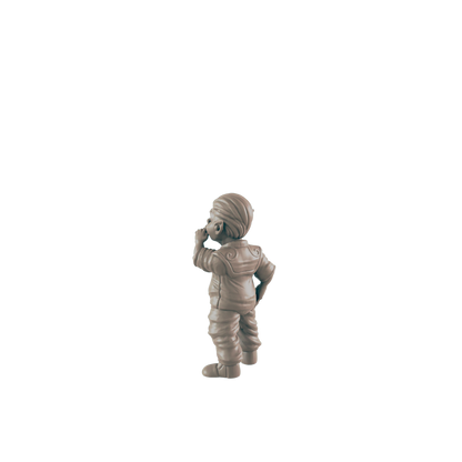 A small figurine of a child stands in contemplation, hand to chin, against a black background.
