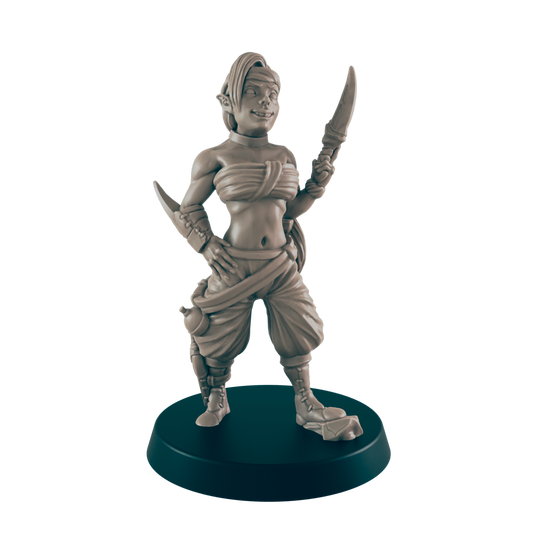 A female miniature figure, wielding a dagger, stands confidently on a dark circular base.  She is depicted in a fantasy setting, wearing loose-fitting clothing.