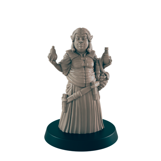 A miniature figurine of a stout, female elf stands on a dark circular base.  She holds a small object in one hand and a bottle in the other, with a satchel at her side.