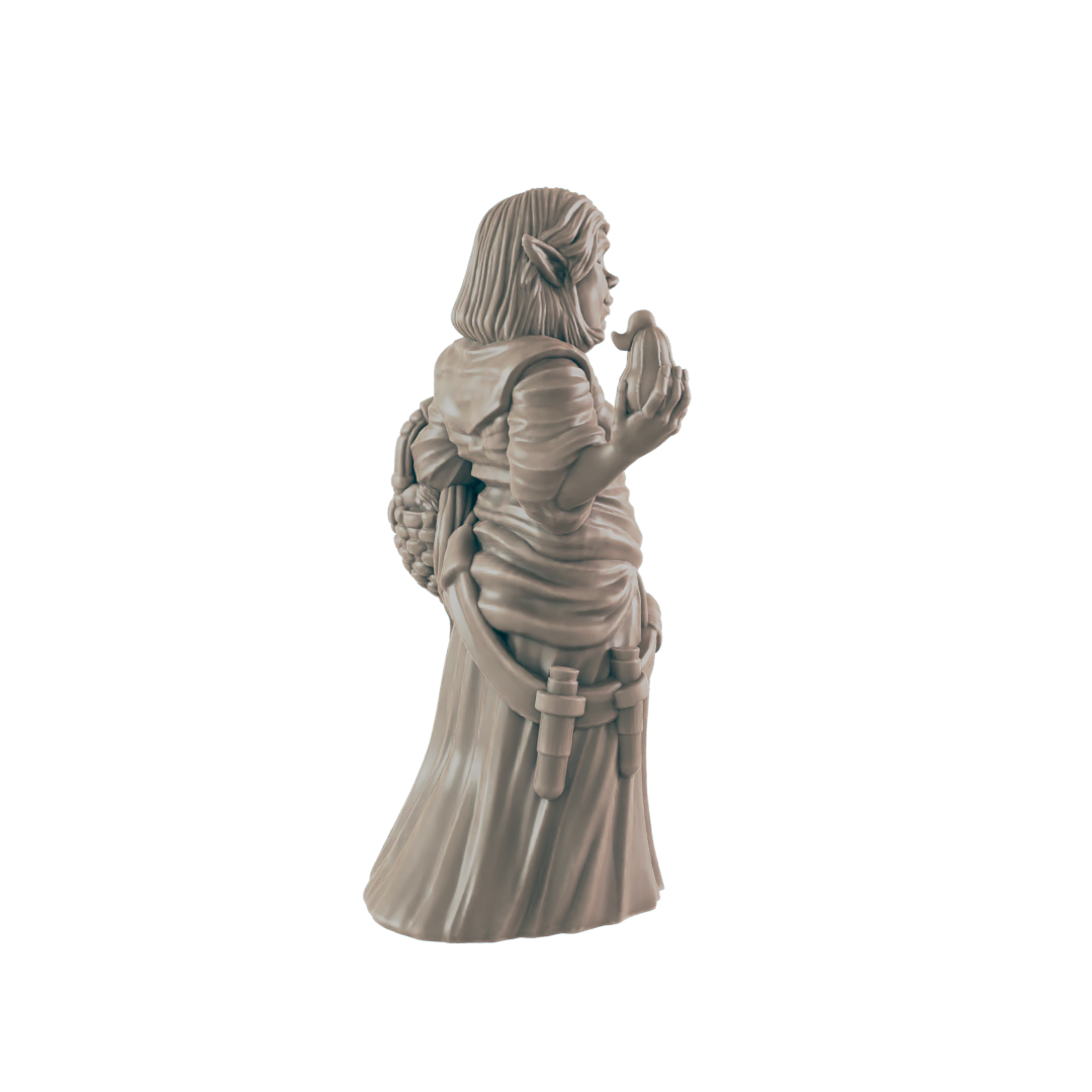 A miniature figurine of a gnome, wearing a robe and holding an object, stands against a black background.