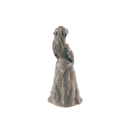 A sculpted woman stands, her back to the viewer, wearing an ornate, flowing gown.  The figure is viewed from behind against a black background.