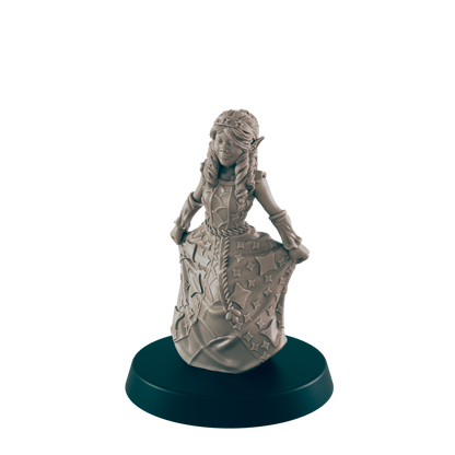A miniature elf girl in a star-covered dress poses on a dark green base. The figure is unpainted and gray against a solid black background.