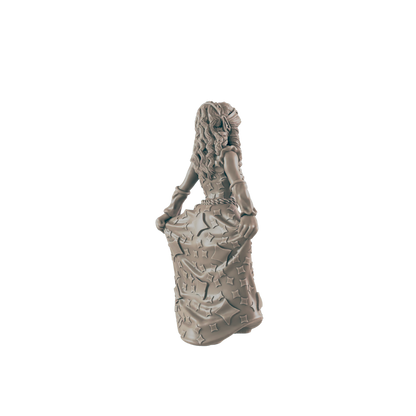 A statue of a woman in a long dress, covered with four-pointed stars, holds the edges of her dress. The figure is positioned from the back.