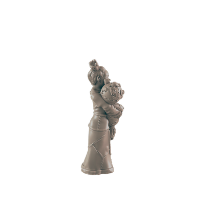 A small figurine of a girl hugs a round object; she wears a long dress. The figurine is light brown and stands alone against a black background.