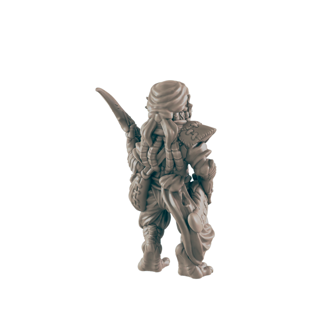 A miniature figurine of a warrior stands, seen from behind, holding a weapon; it is positioned against a black background.