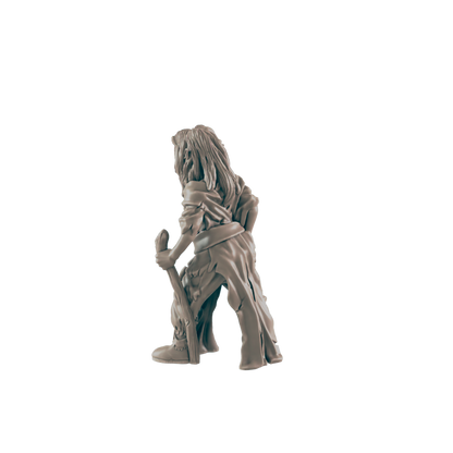 A miniature figurine of a hunched, long-haired figure holds a staff, appearing to stand against a dark background.