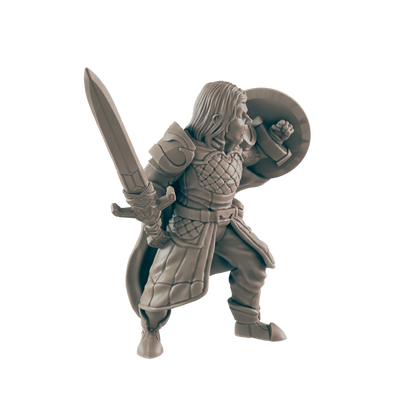 A miniature warrior, wielding a sword and shield, stands in a battle-ready stance.
