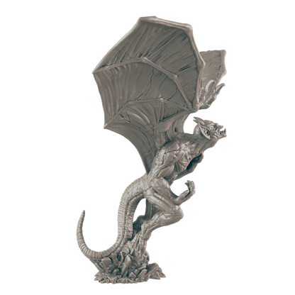A gray, winged gargoyle miniature is perched on a rocky base.  It is posed in a dynamic, upward stance.