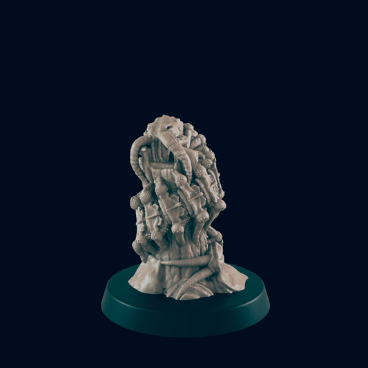 A beige, organic sculpture, resembling a parasitic growth, sits on a dark circular base against a black background.