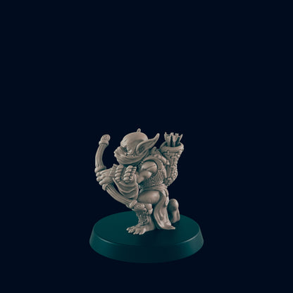 A grey-toned goblin figurine kneels on a round, green base, aiming a bow with arrows in a quiver on its back, against a dark blue backdrop.