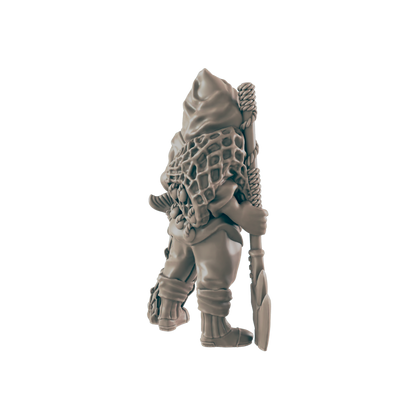 A miniature gnome figure, carrying a shovel and net, stands against a dark background.
