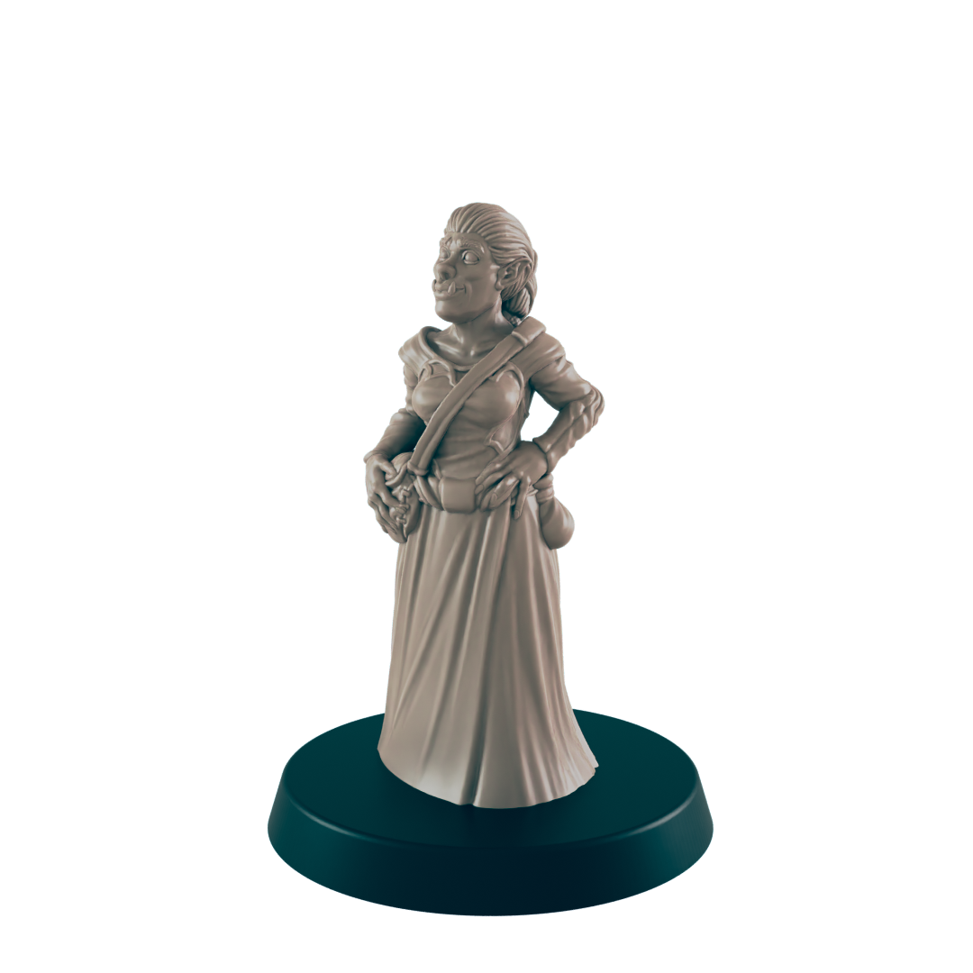 A female orc miniature stands on a circular base; she wears a long dress and satchel, hands on hips.