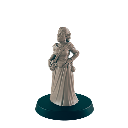 A female orc miniature stands on a circular base; she wears a long dress and satchel, hands on hips.