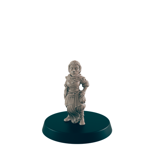 A small, female figurine stands on a dark circular base.  She appears to be wearing a robe and boots. The figurine is light beige in color.