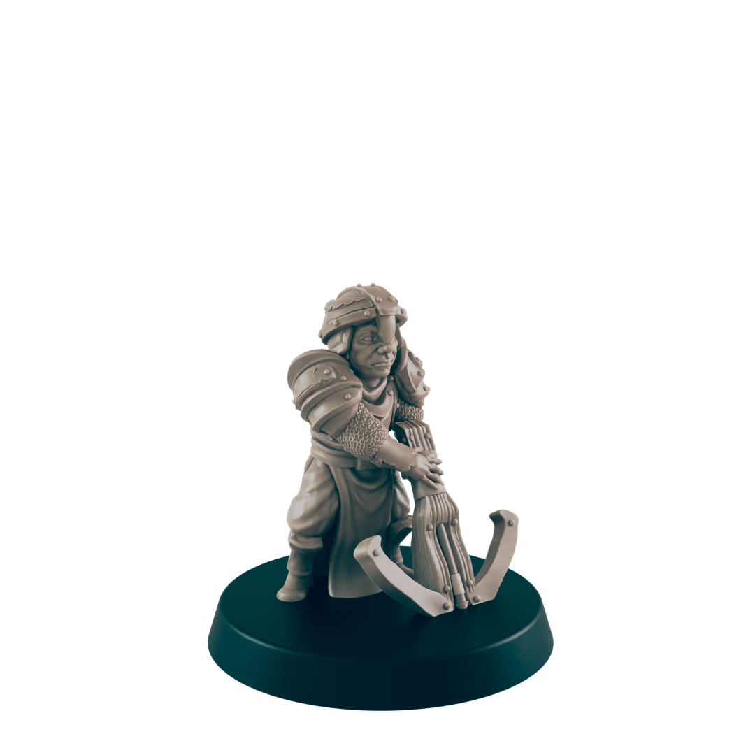 A miniature armored figure operates a crossbow; it stands on a dark circular base against a plain background.