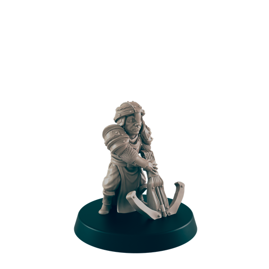 A miniature armored figure operates a crossbow; it stands on a dark circular base against a plain background.