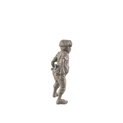 A small boy figurine stands, appearing to adjust his trousers, against a black background.