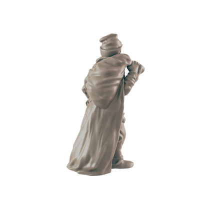 A miniature figurine of a cloaked figure carries a large sack on their back against a dark background.