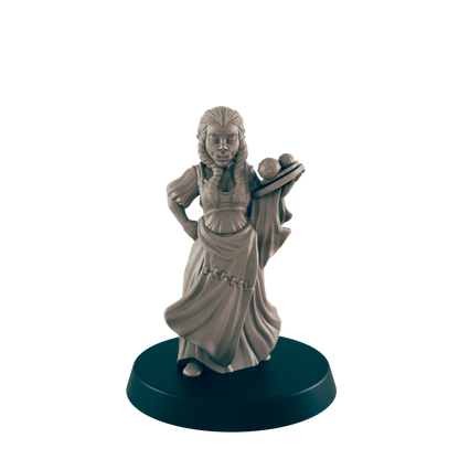 A miniature, light-brown female figure, dressed in peasant-style clothing, holds a tray of spherical objects. The figure stands on a black, circular base against a black backdrop.