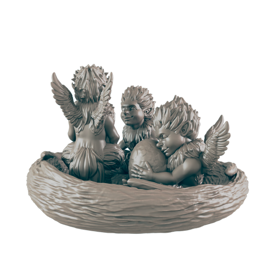 Three winged fairy-like figures sit in a nest, one clutching an egg. The figures have pointy ears and feathery collars, against a black background.