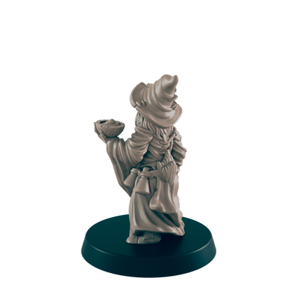A miniature wizard figurine holds a bowl, stands on a dark base.