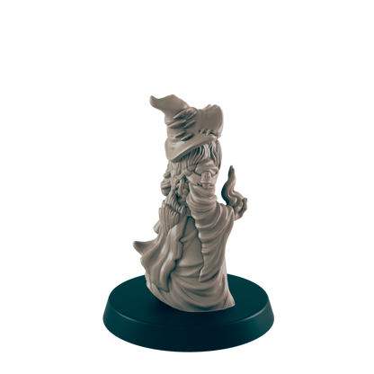 A miniature wizard figurine stands on a dark circular base.  The figure is sculpted in a robe and pointed hat, appearing to cast a spell.