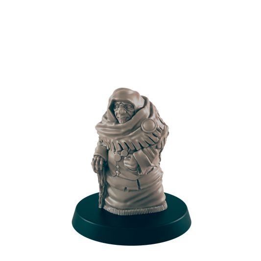 A miniature figurine of an elderly person, wearing a hooded cloak and holding a staff, stands on a dark circular base.