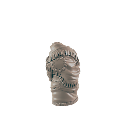 A sculpted torso, seemingly wrapped in tattered fabric, sits against a dark background.