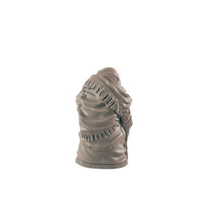 A sculpted figurine, seemingly depicting a cloaked figure, stands alone against a black background.