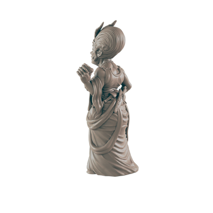 A sculpted figurine of a woman, standing in a flowing gown, is posed with hands clasped.  The figure appears to be a fantasy character.