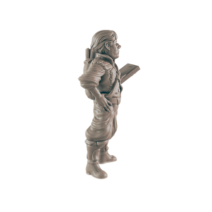 A miniature figurine of a stout, backpack-wearing man holds a flat object, standing against a dark background.