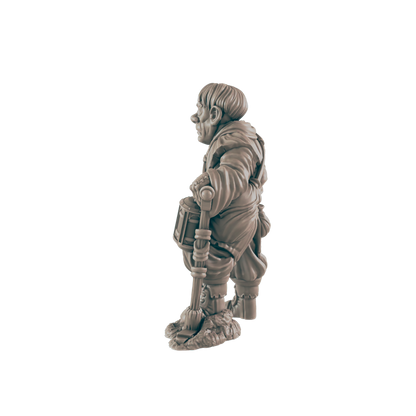 A small, stout figurine of a dwarf holds a drum, standing on a textured base against a dark background.