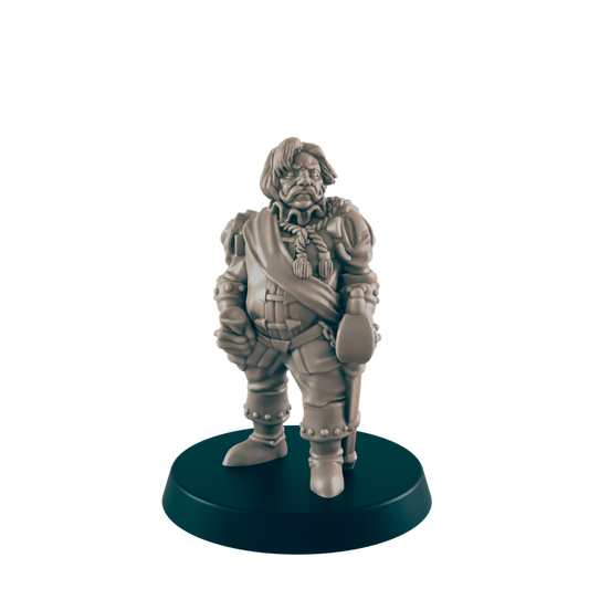 A miniature figurine of a stout man stands; he is dressed in 17th-century attire and holds objects in both hands, on a dark circular base.