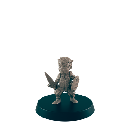 A miniature figurine of a young warrior, wielding a sword and shield, stands on a dark circular base.