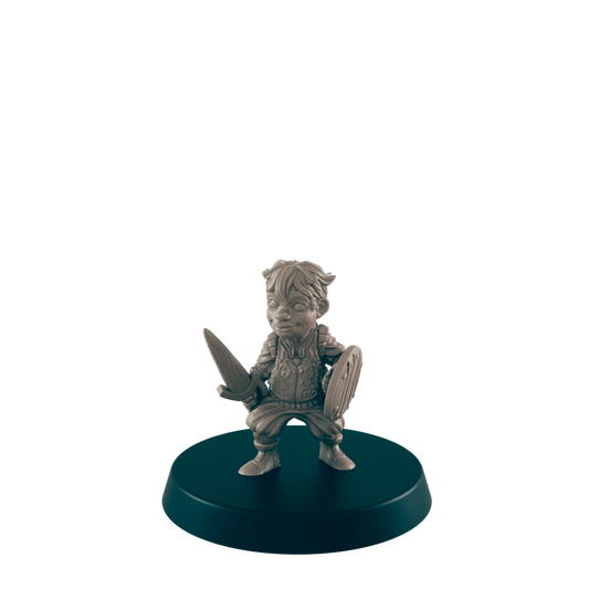 A miniature figurine of a young warrior, wielding a sword and shield, stands on a dark circular base.