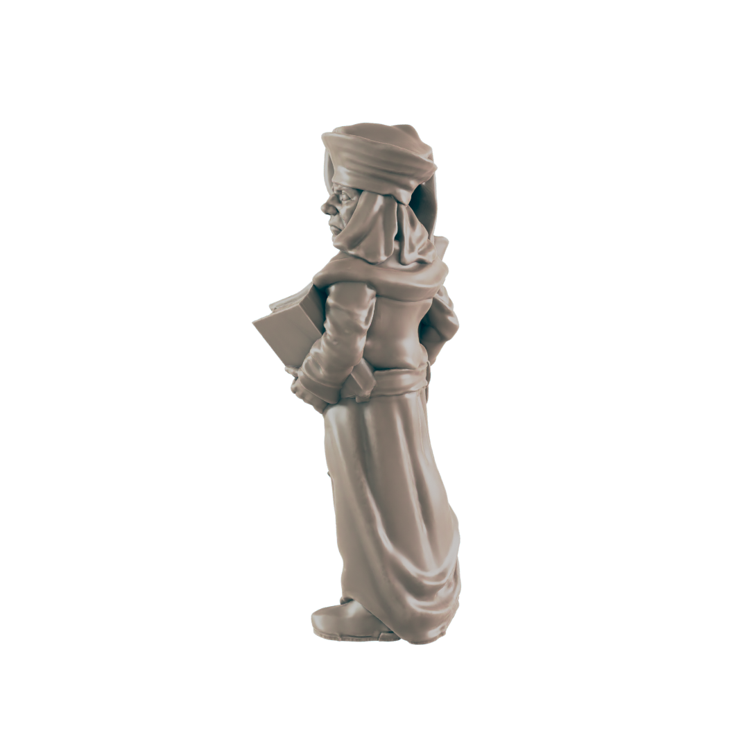 A miniature figurine of a robed figure holding a book stands against a black background.