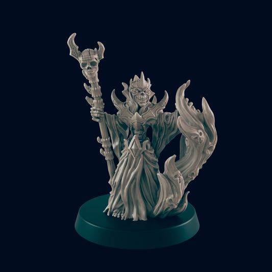 A skeletal figure, possibly a lich, stands holding a skull-topped staff, emanating from a dark, swirling flame-like effect, all displayed on a dark circular base.