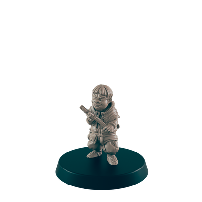A small, grey figurine of a gnome-like character holds a staff, standing on a dark circular base.