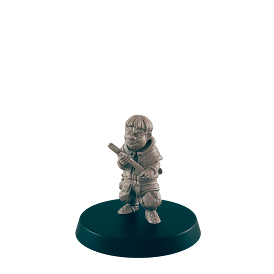A small, grey figurine of a gnome-like character holds a staff, standing on a dark circular base.