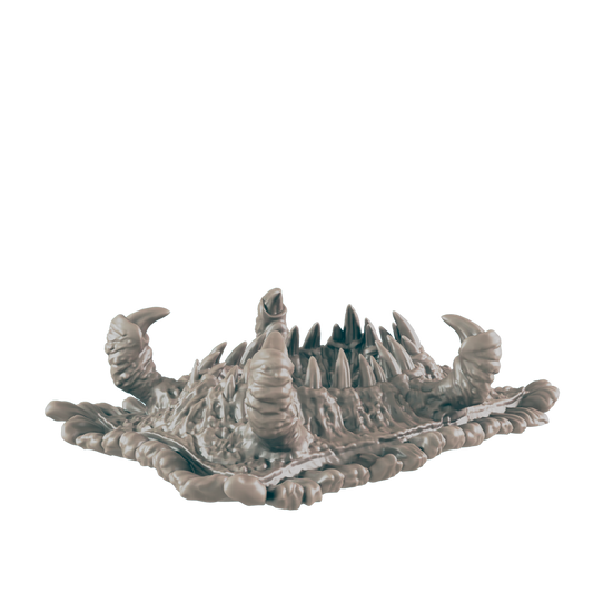 A monstrous, spiky creature rests on a textured base.  It is light gray and appears to be sculpted. The background is dark.