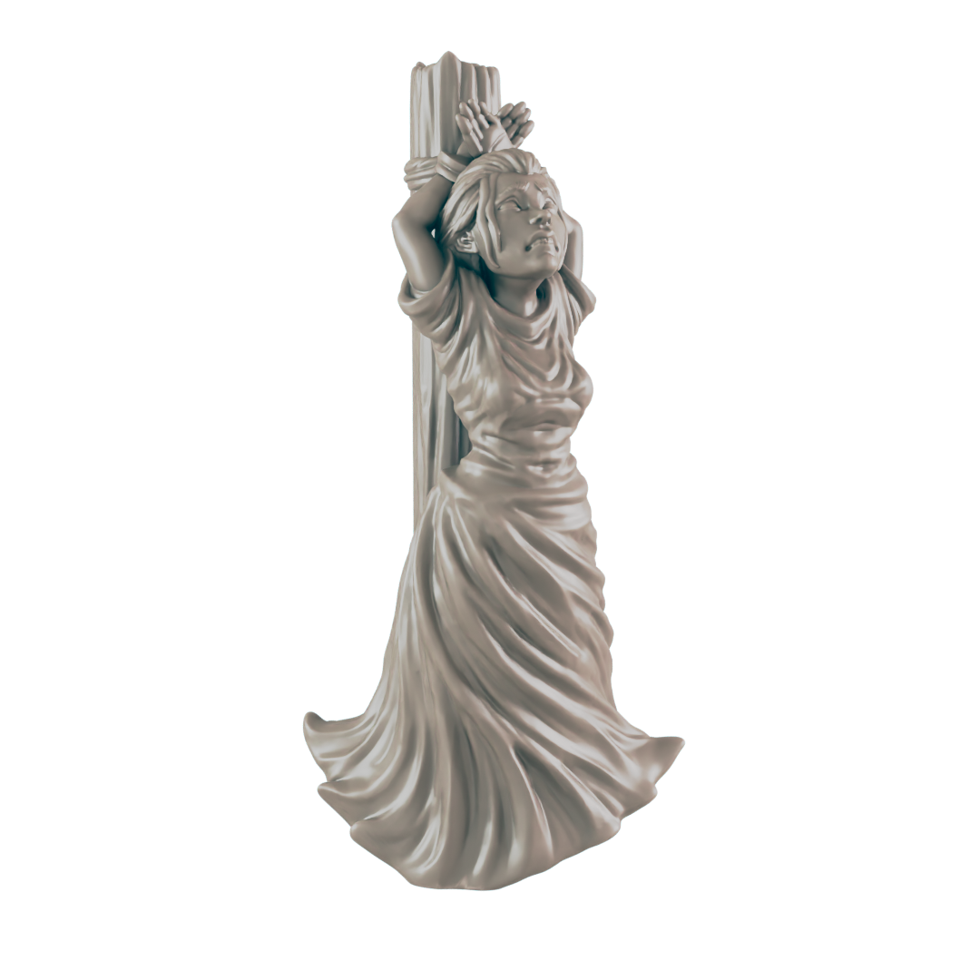 A miniature figurine of a woman, bound to a post, stands against a dark background.