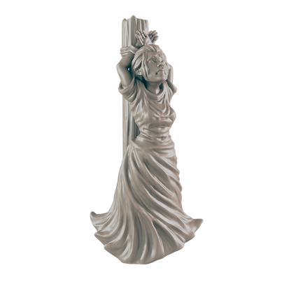 A miniature figurine of a woman, bound to a post, stands against a dark background.