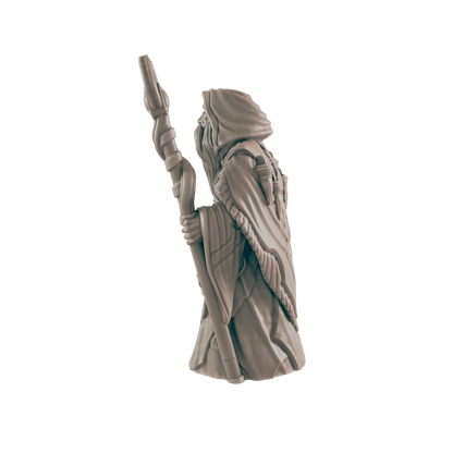 A miniature wizard figurine stands, holding a staff; against a dark background.
