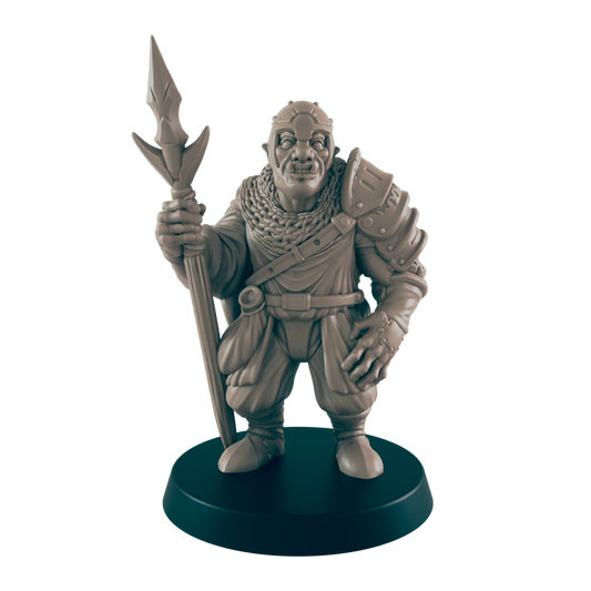 A miniature orc figure stands holding a spear.  He wears armor and a cloak.  The figure is displayed on a dark circular base.